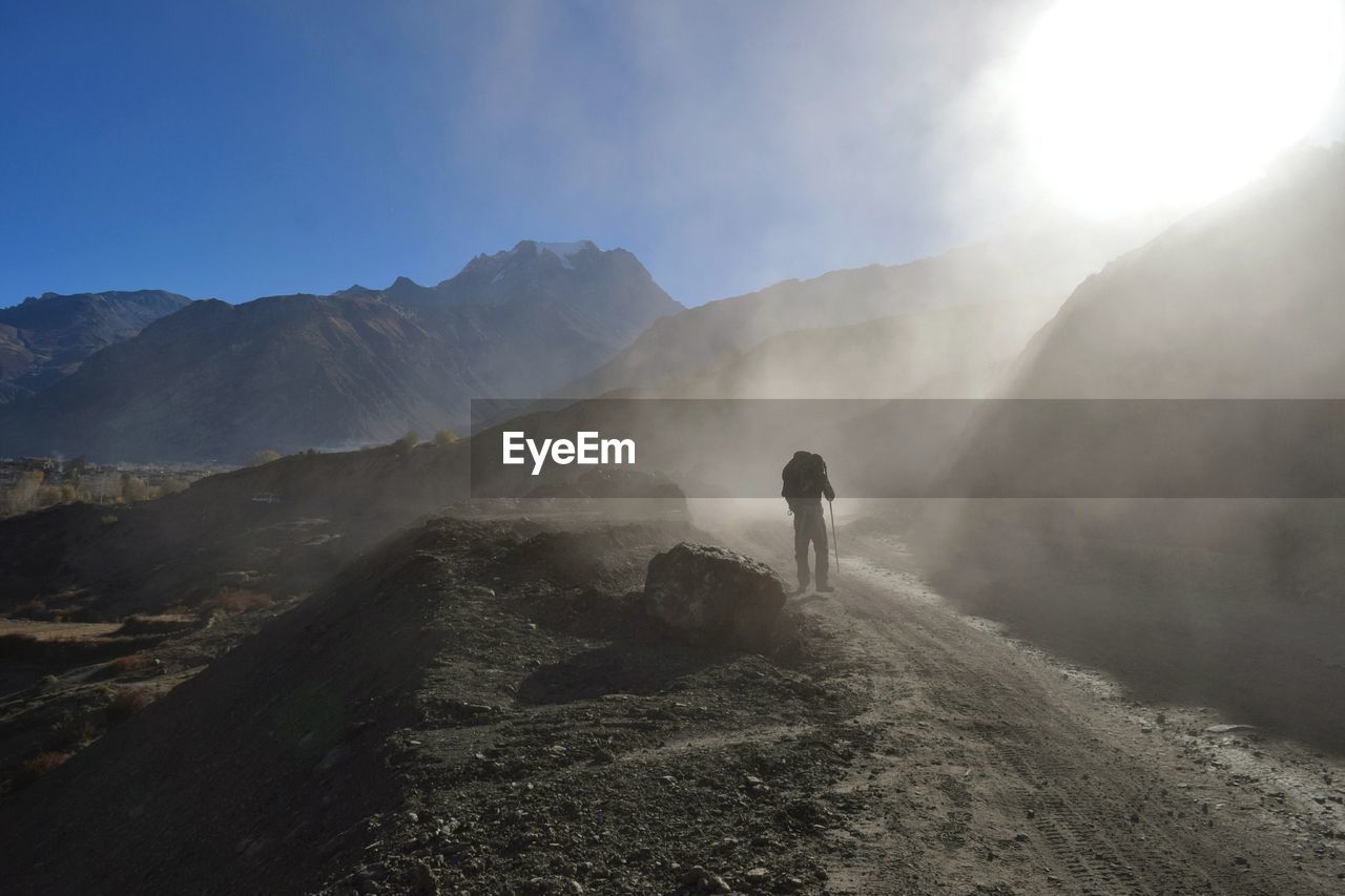 Hiker on mountain against sky