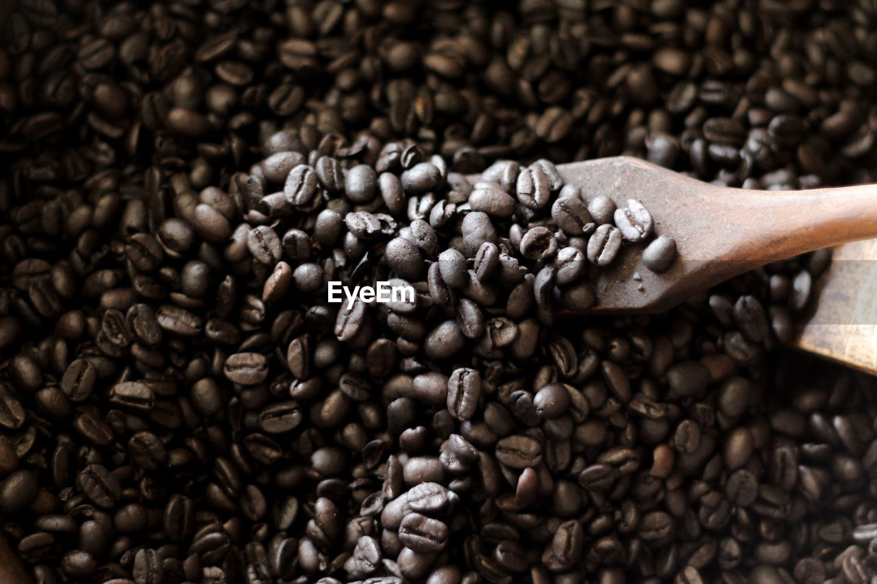 CLOSE-UP OF COFFEE BEANS IN FOREGROUND