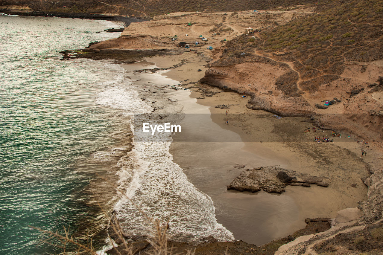 HIGH ANGLE VIEW OF ROCK FORMATIONS ON SHORE