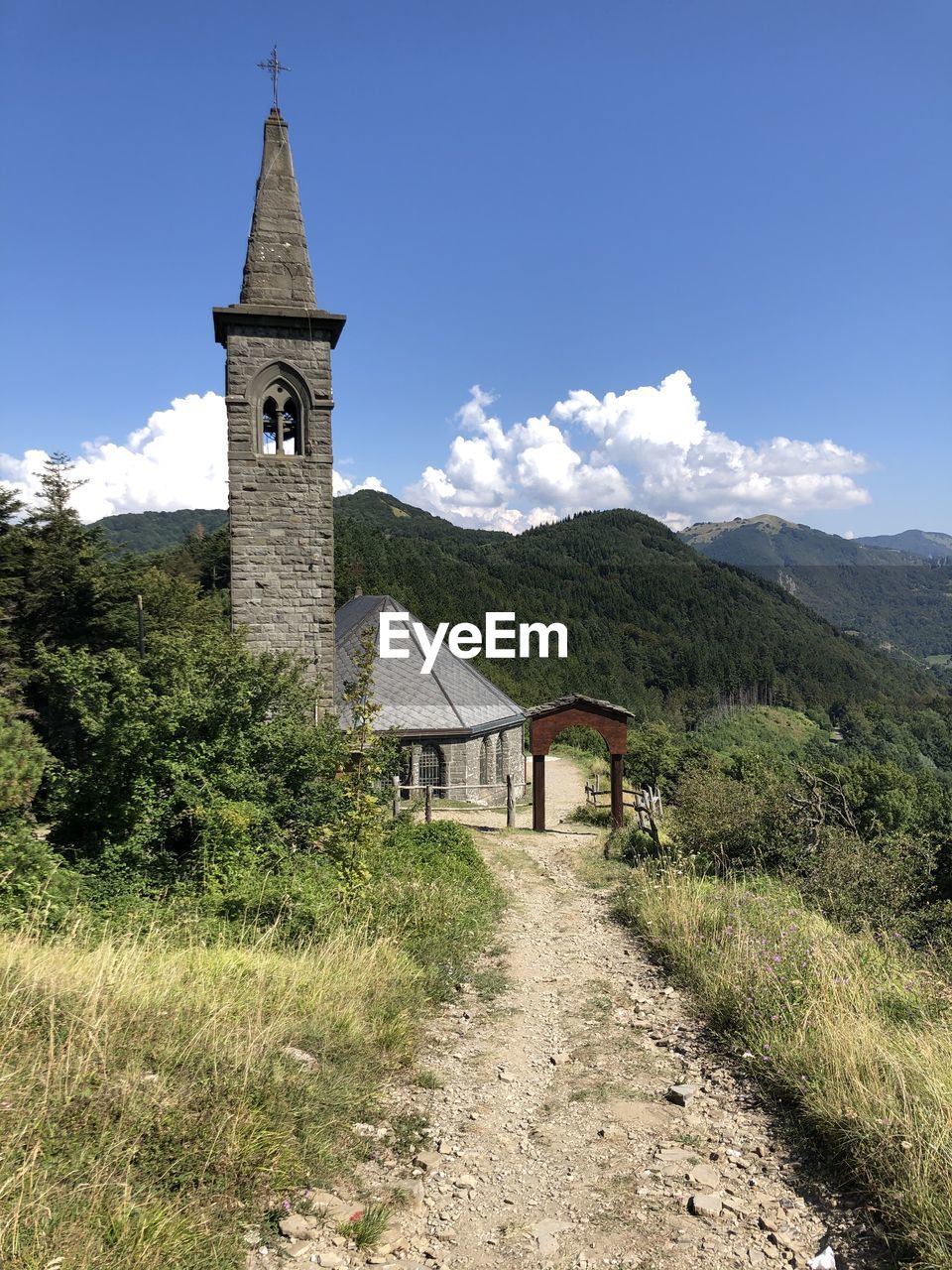 Walkway amidst church against sky, cisa italy 