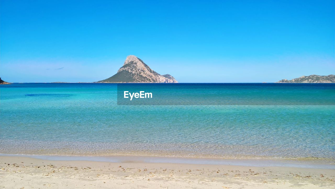 Scenic view of sea against clear blue sky