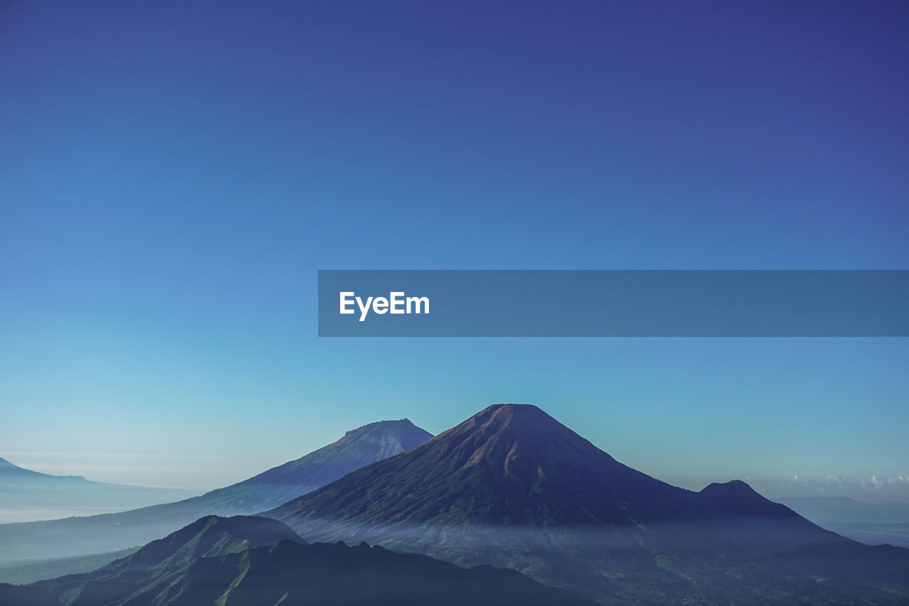 SCENIC VIEW OF MOUNTAIN AGAINST BLUE SKY