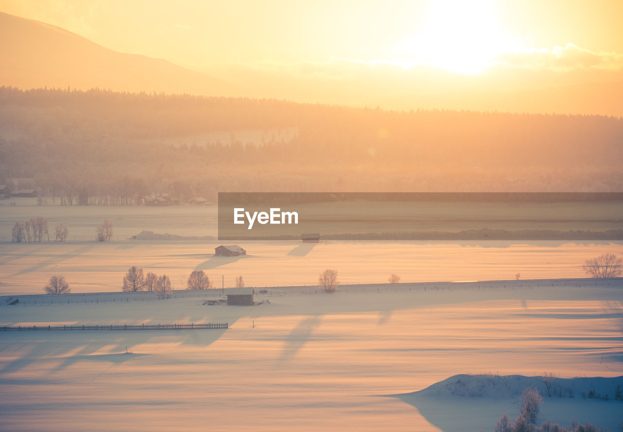 Scenic view of lake against sky during sunset