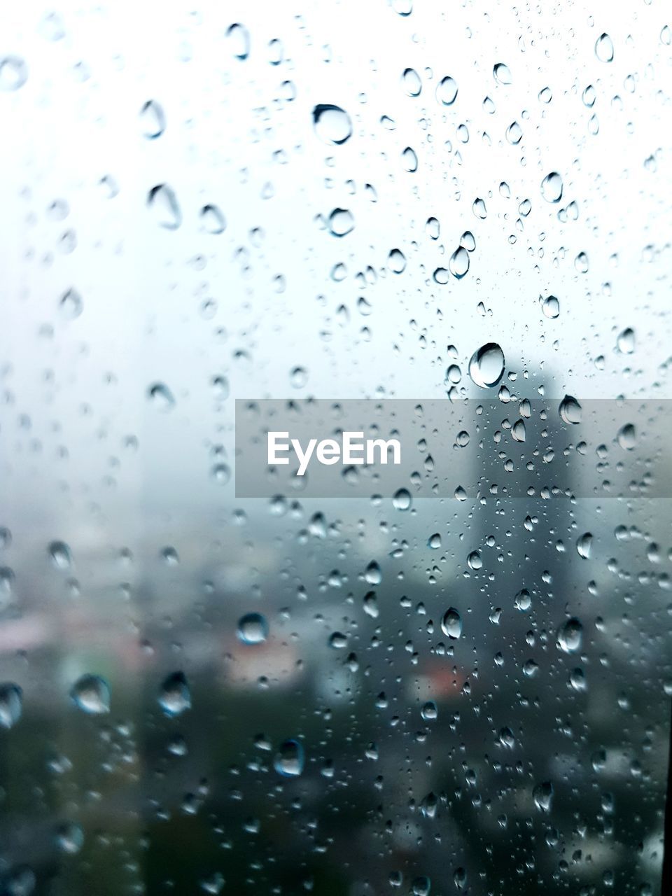 FULL FRAME SHOT OF RAINDROPS ON GLASS WINDOW