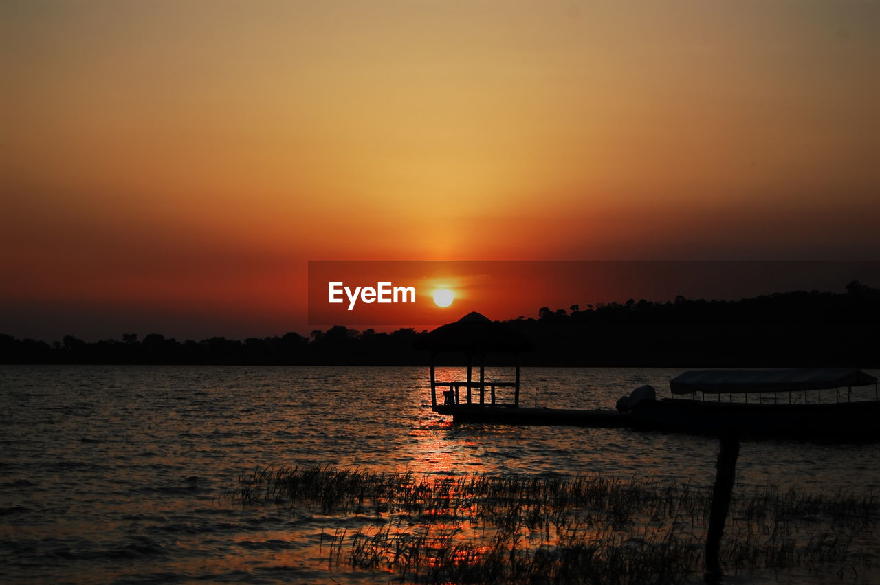 Sunset over lake victoria with sun reflecting in water