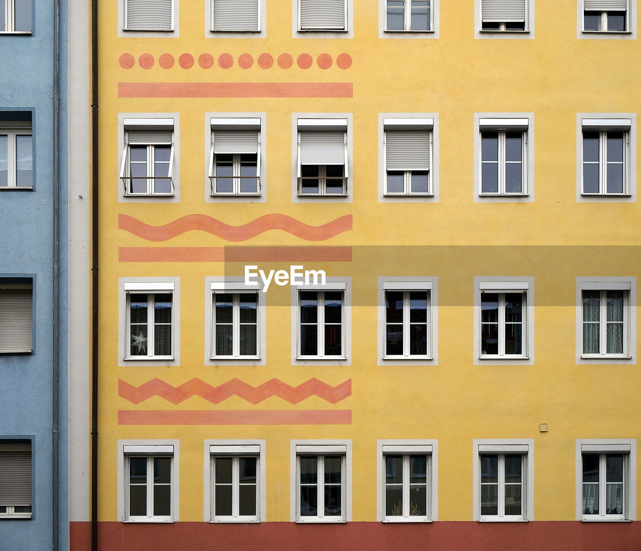 CLOSE-UP OF YELLOW APARTMENT BUILDING