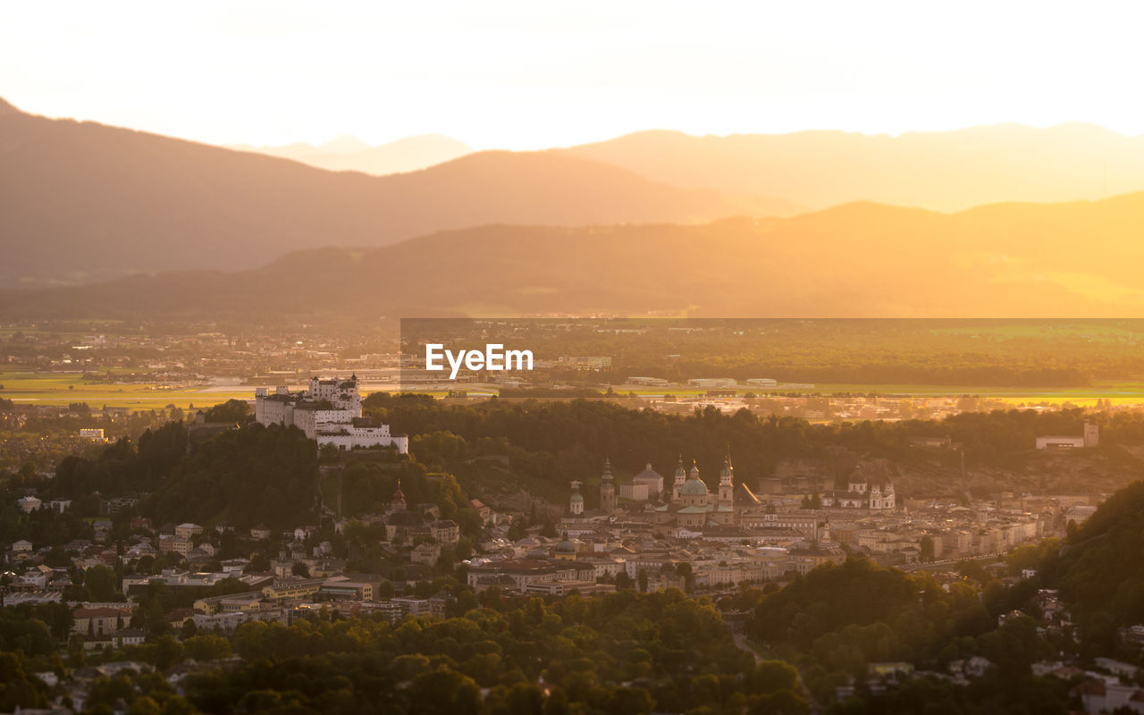 Townscape against mountains during sunset