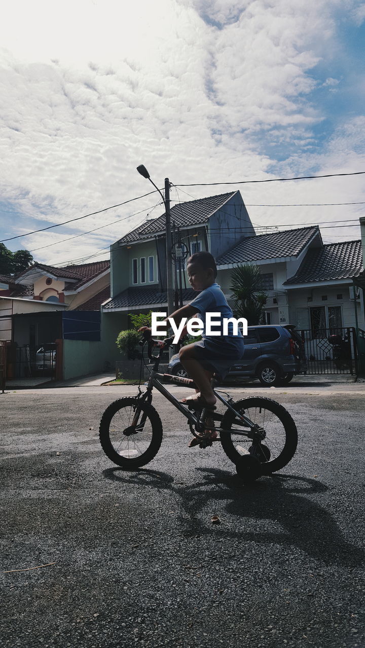 BICYCLES ON ROAD AGAINST SKY