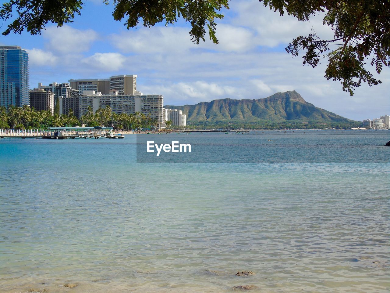 SCENIC VIEW OF SEA AGAINST BUILDINGS IN CITY