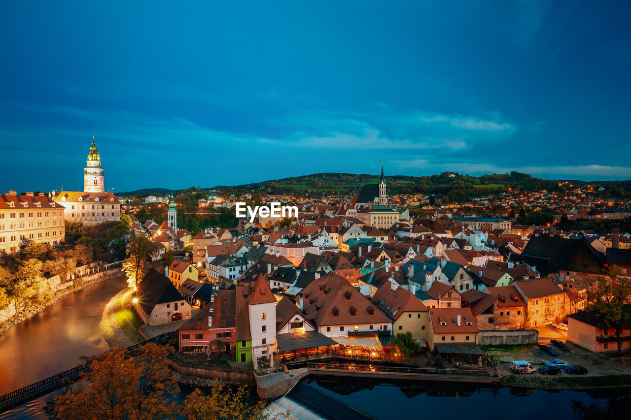 HIGH ANGLE VIEW OF ILLUMINATED BUILDINGS IN CITY