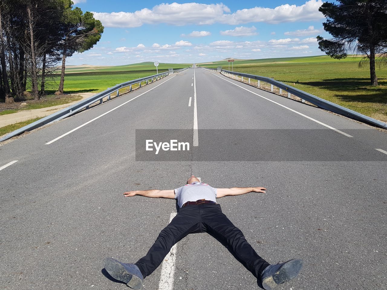 Full length of man lying on road