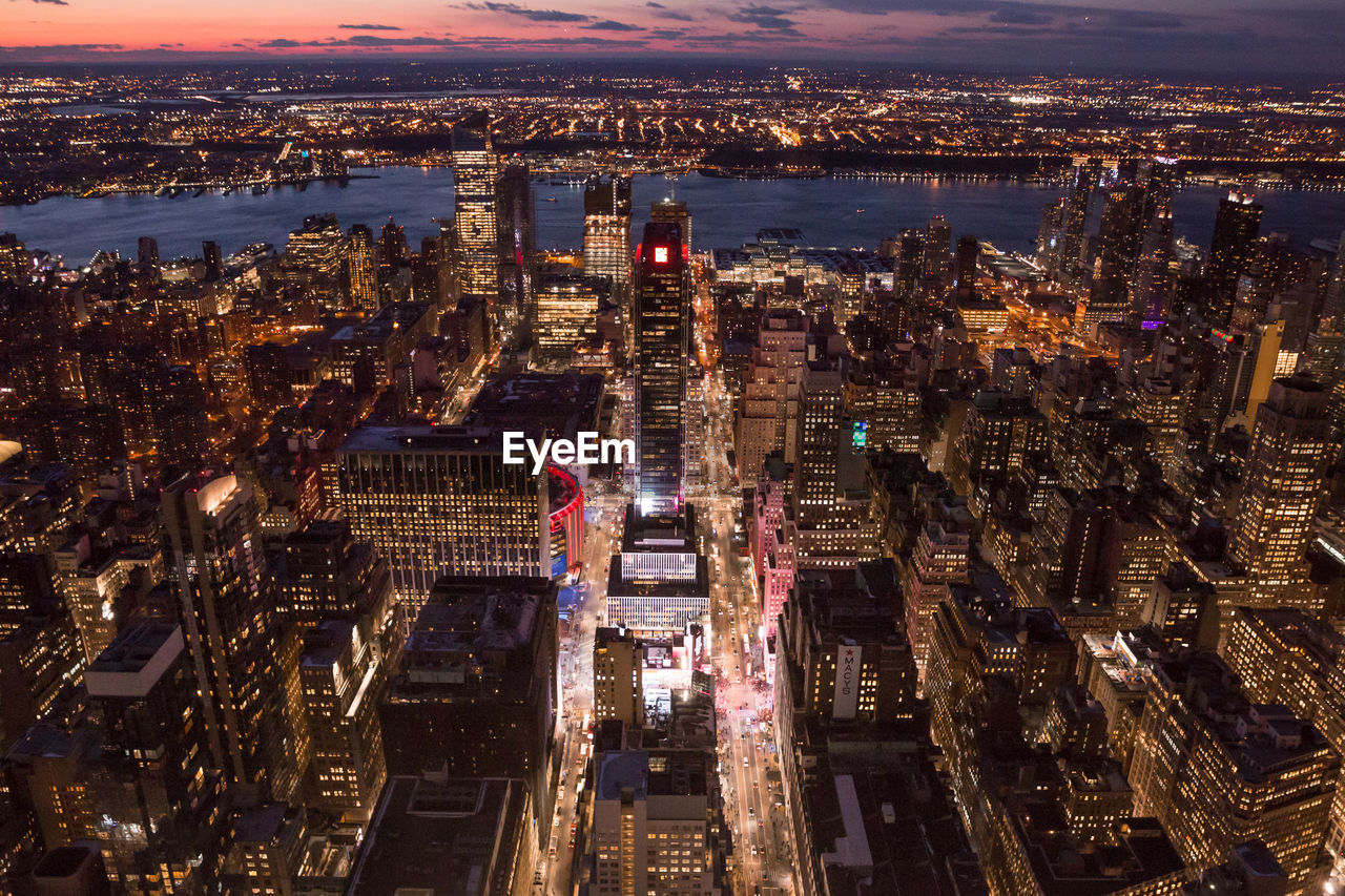 High angle view of city lit up at night