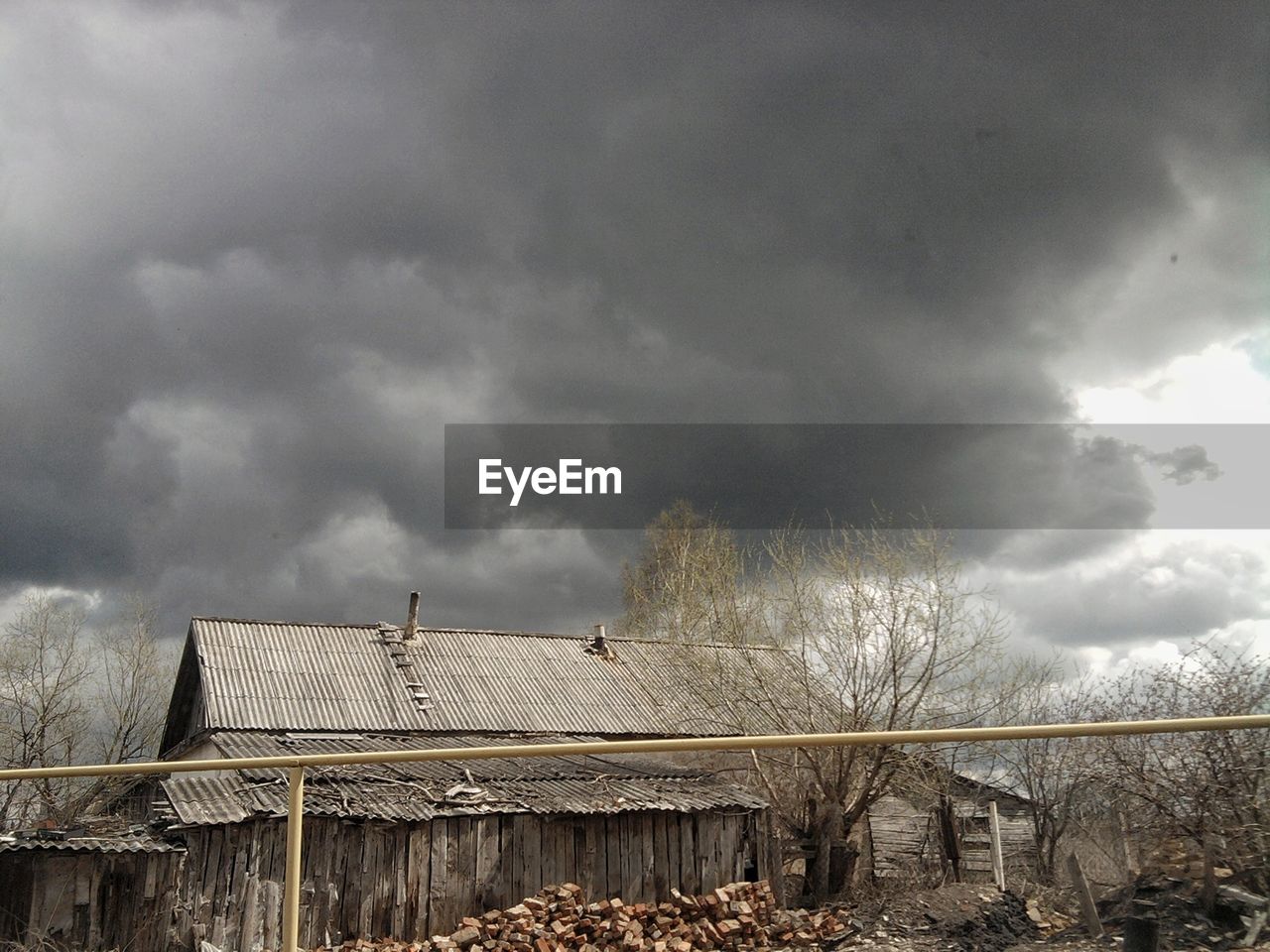 HOUSES AGAINST CLOUDY SKY