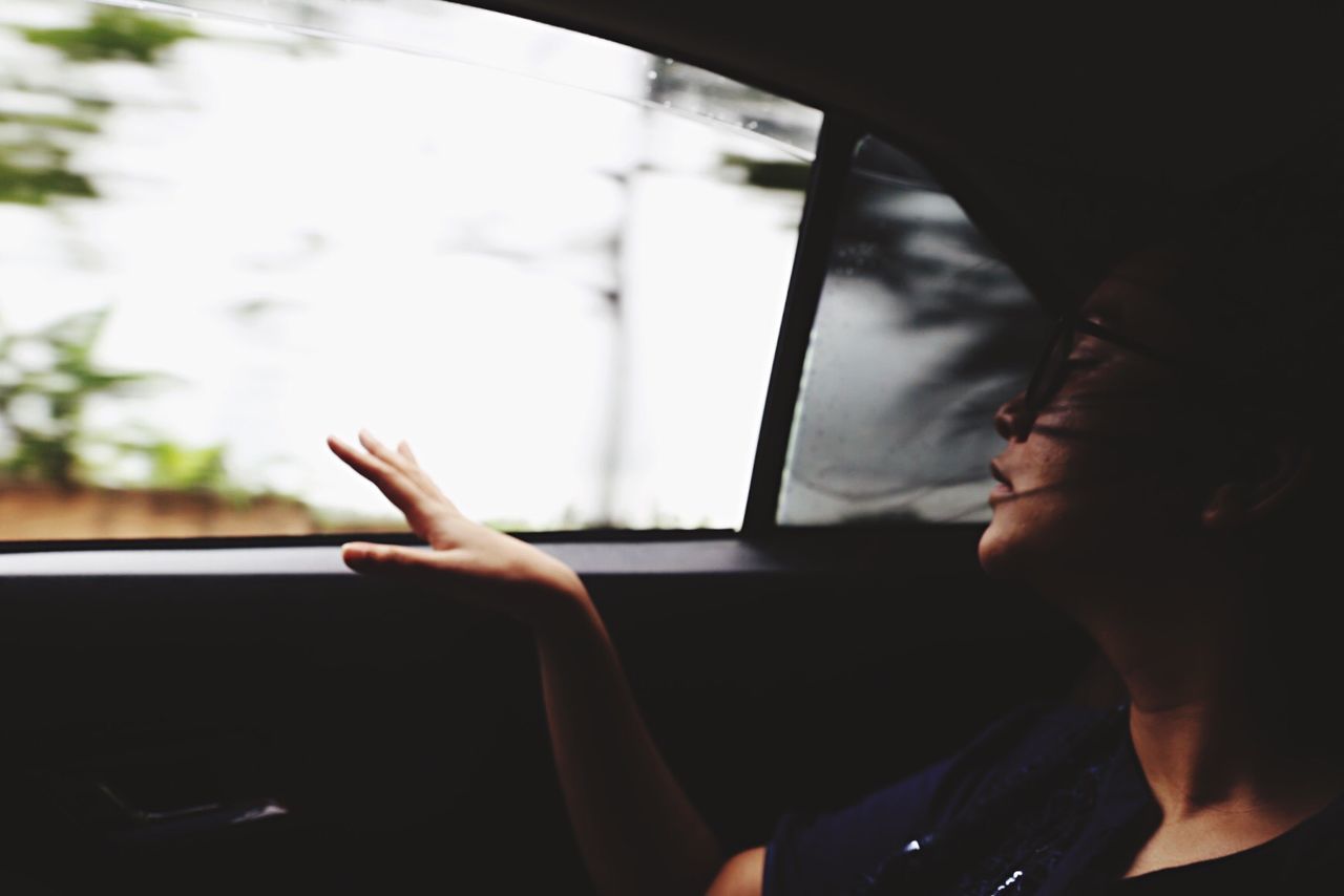 CLOSE-UP OF WOMAN IN CAR WINDOW