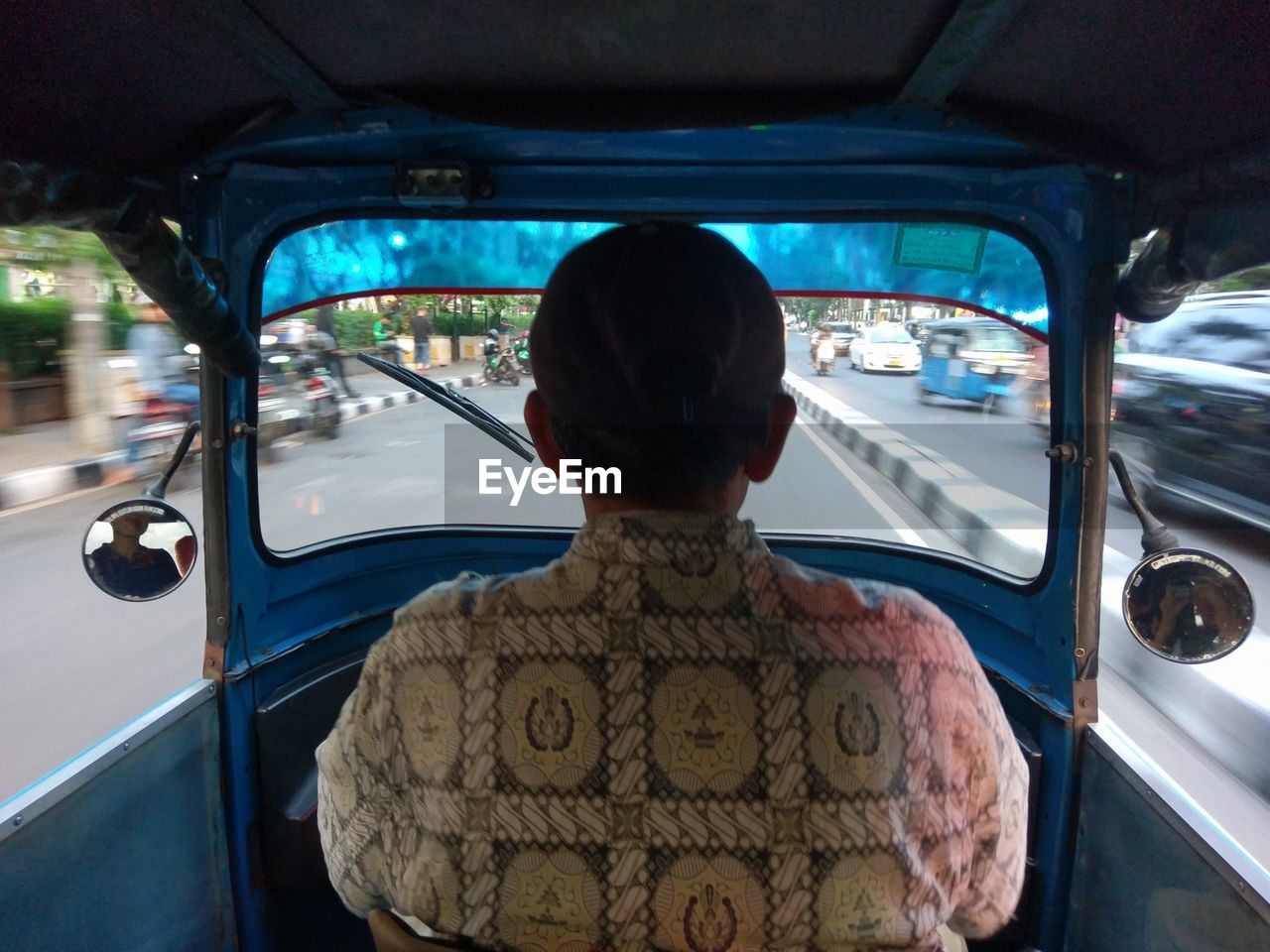 REAR VIEW OF MAN STANDING IN BUS