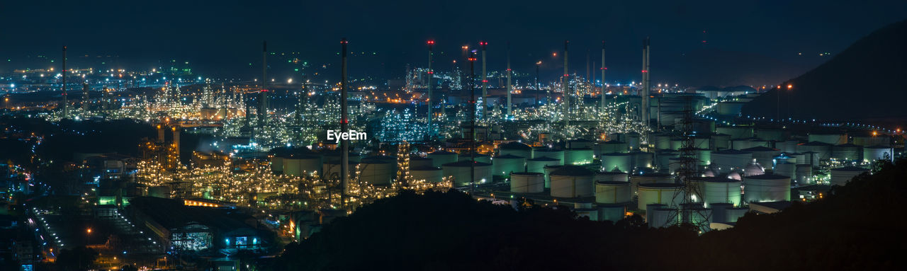 HIGH ANGLE VIEW OF ILLUMINATED CITY BUILDINGS AT NIGHT