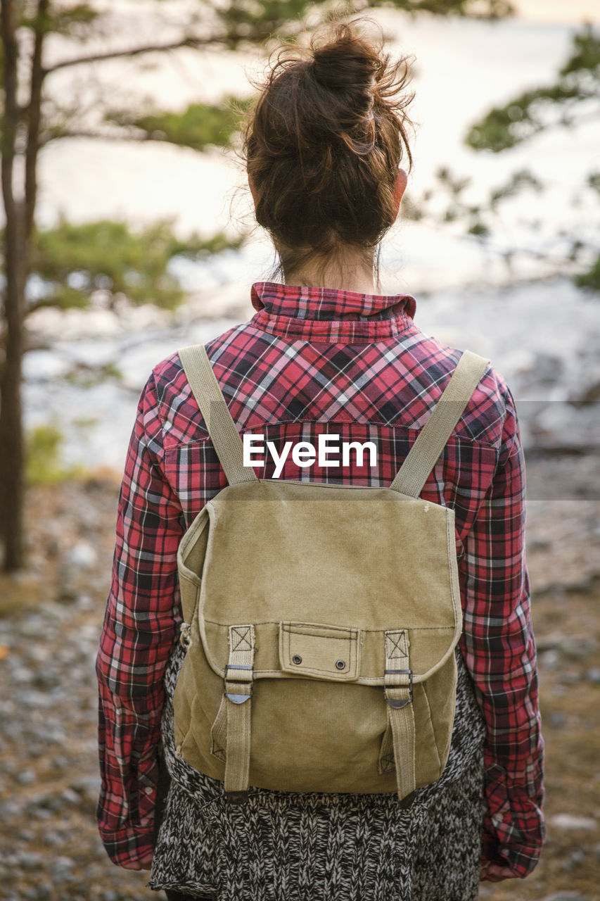 Rear view of woman hiking in forest