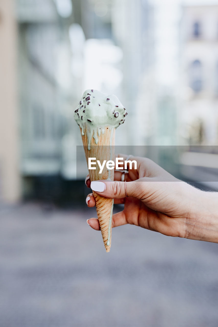 Cropped hand of woman holding ice cream cone