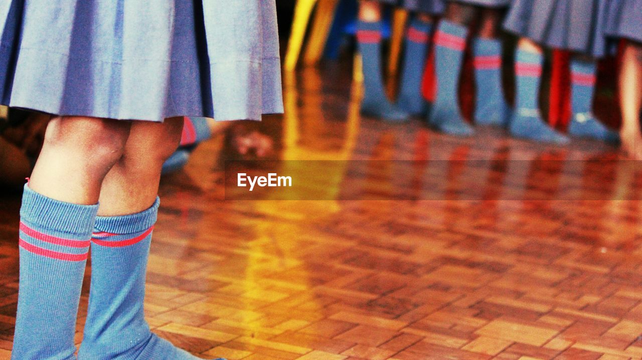 Low section of woman standing on tiled floor