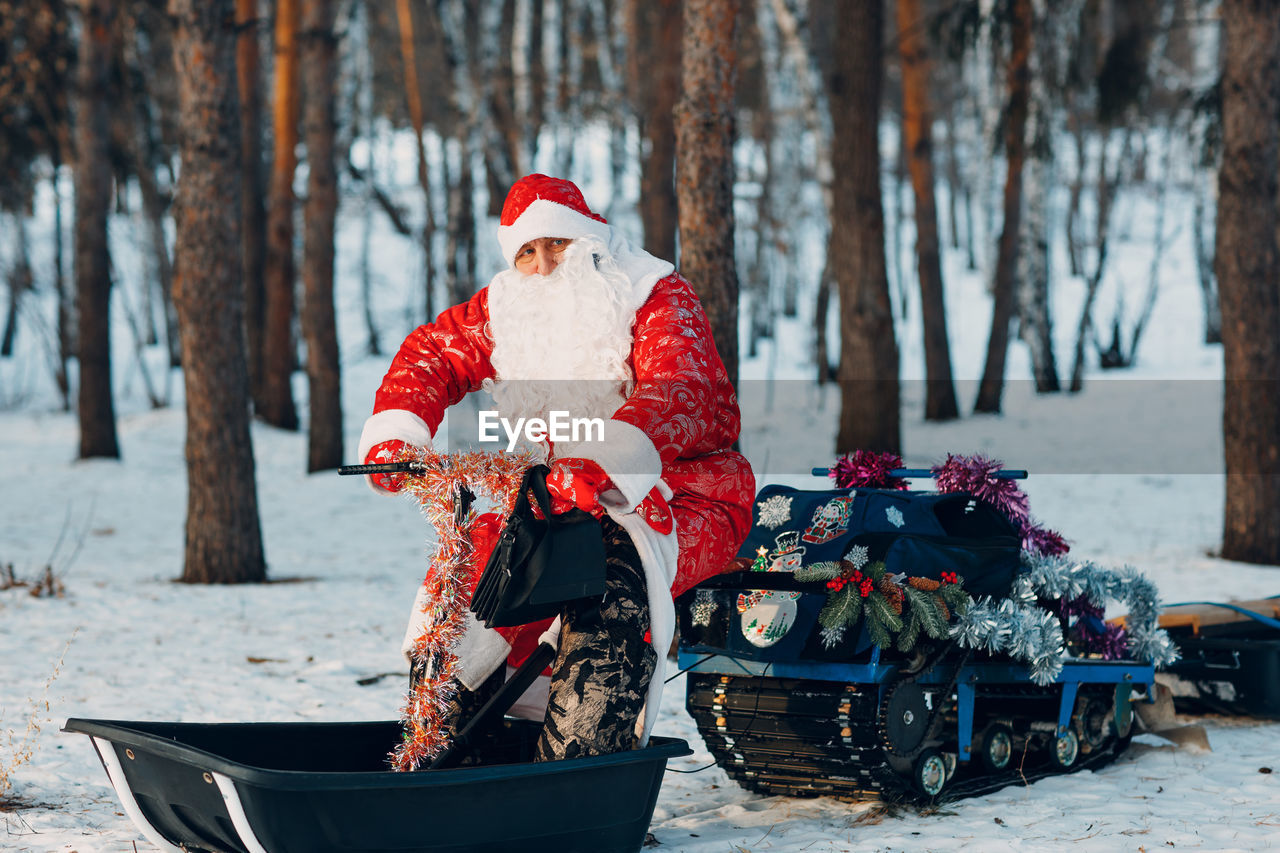 low angle view of man standing in forest during winter