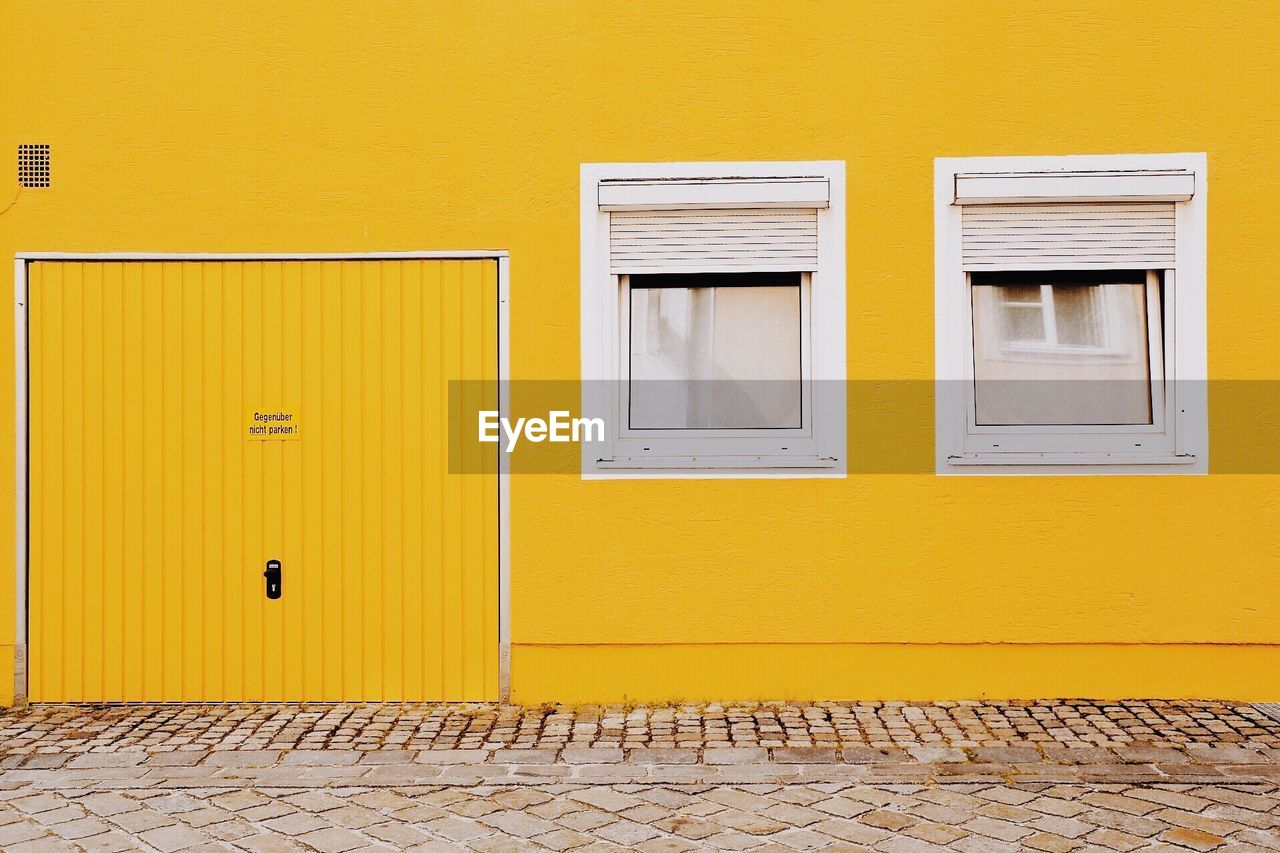 View of windows on yellow wall