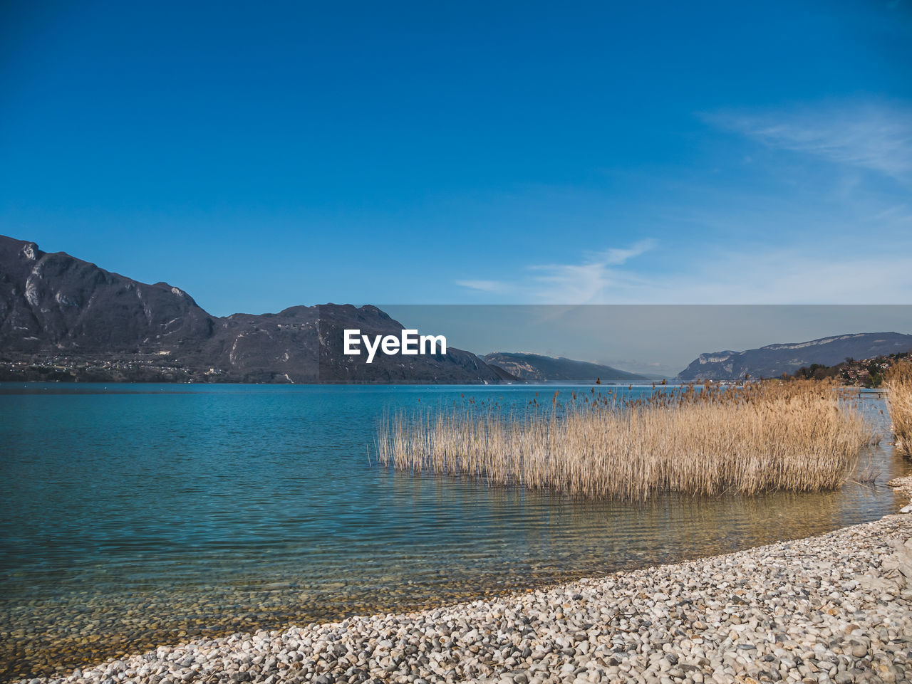 Scenic view of lake against blue sky