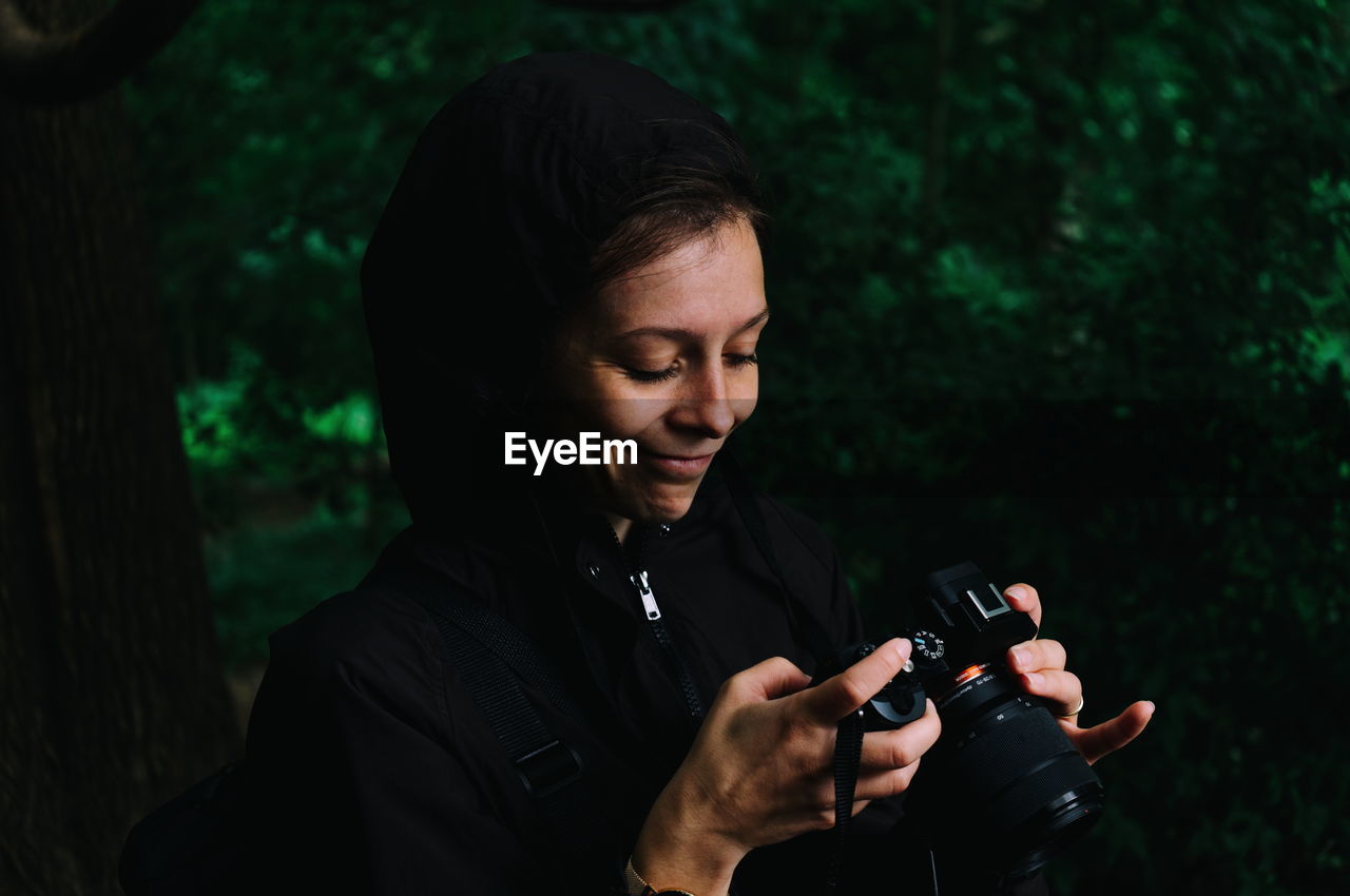 Young woman holding camera