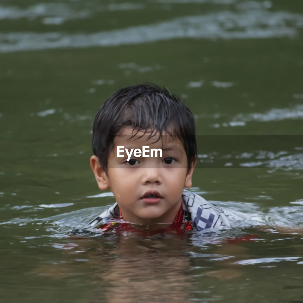 Portrait of boy swimming in water