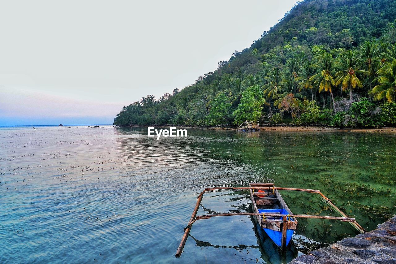 Scenic view of boat on sea against sky