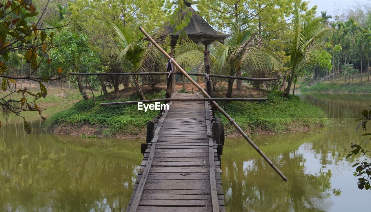 WOODEN BRIDGE OVER LAKE