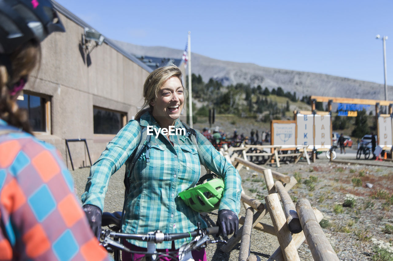 A young woman laughs during a rest at timberline bike park in oregon.