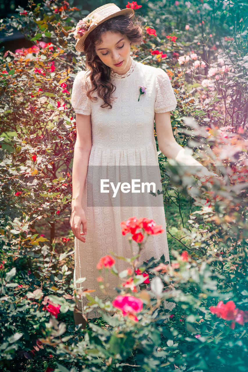 PORTRAIT OF YOUNG WOMAN IN PLANT