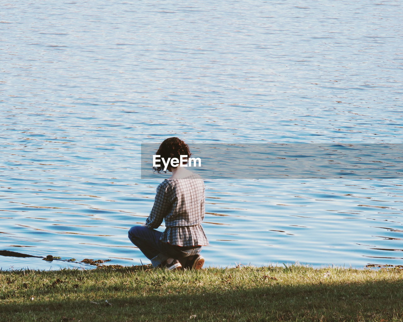 Rear view of woman looking at lake