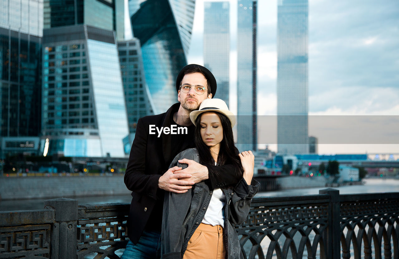 Couple in love on the background of city buildings