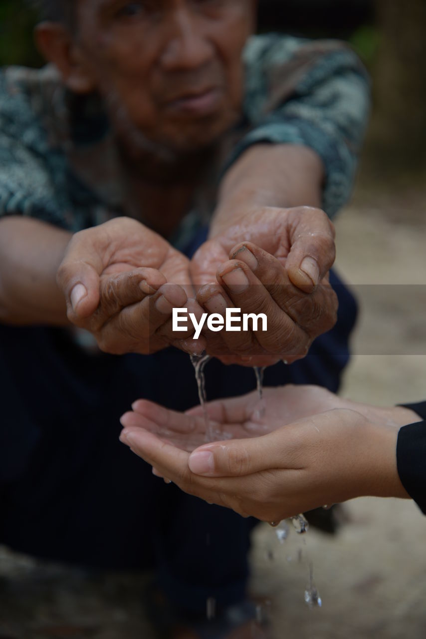 People pouring water outdoors