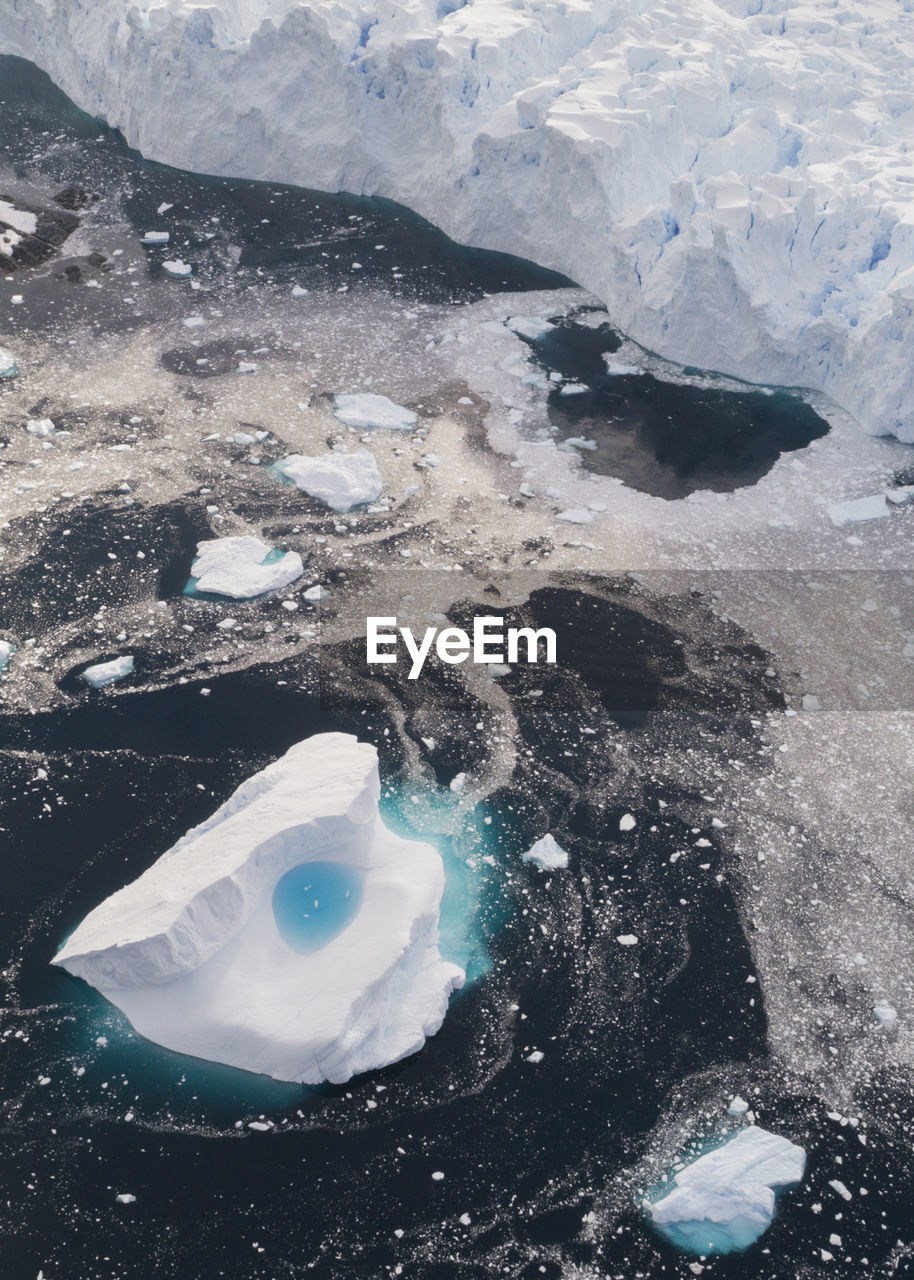 Aerial view of a glaciär front with iceberg at brabant island, palmer archipelago, antarctica 