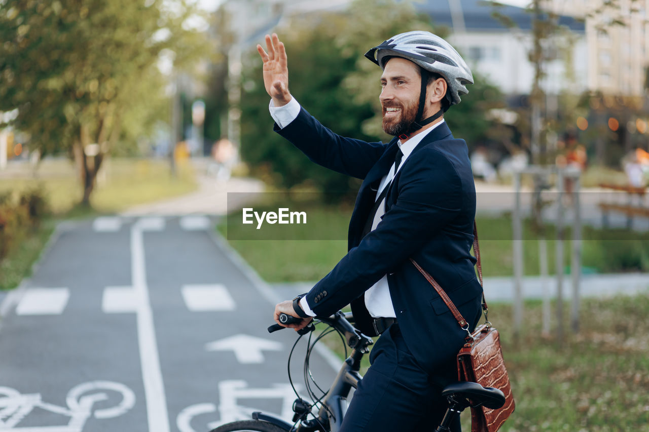 side view of young man riding bicycle on street