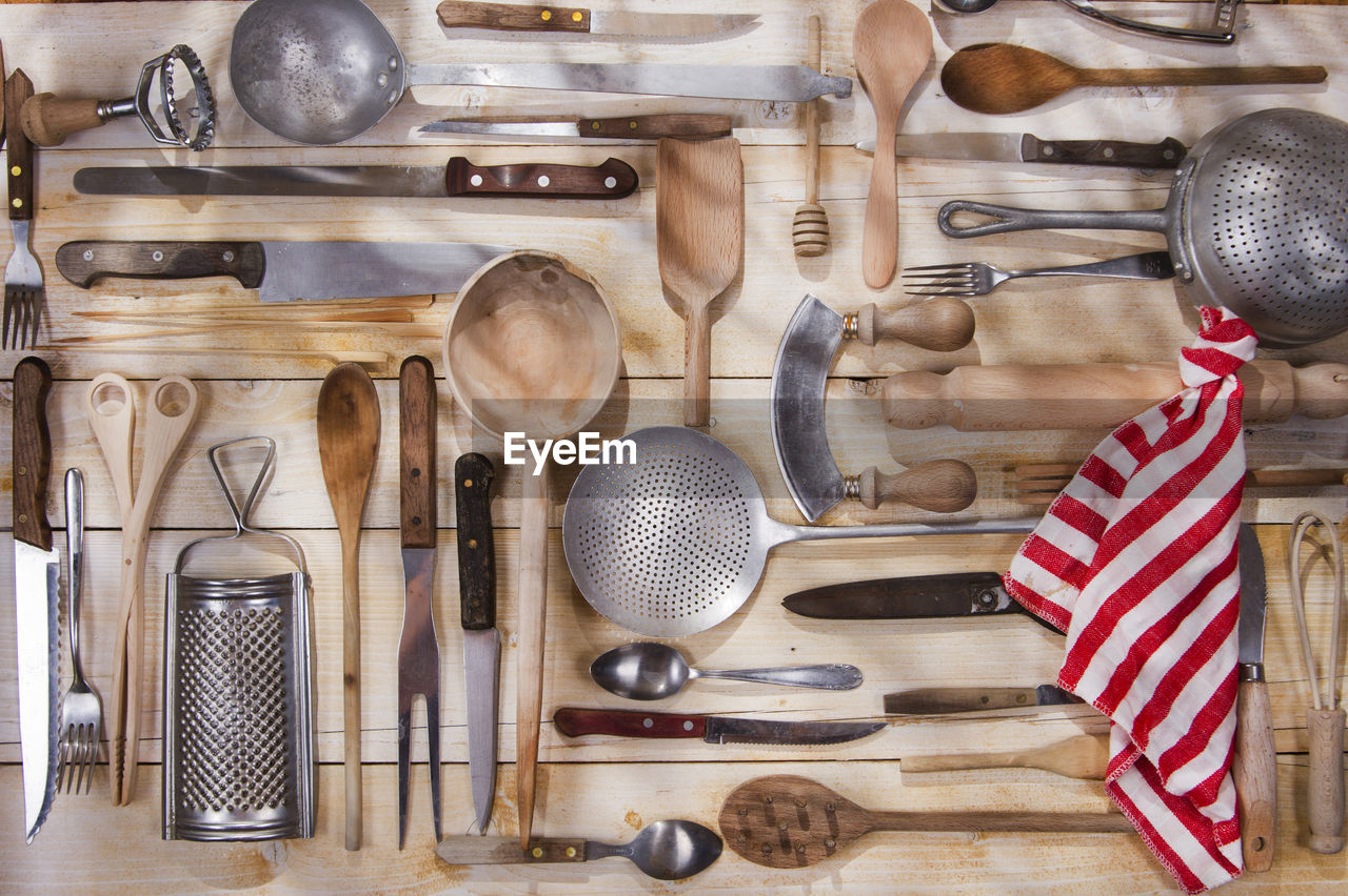 Various kitchen utensils hanging on wood