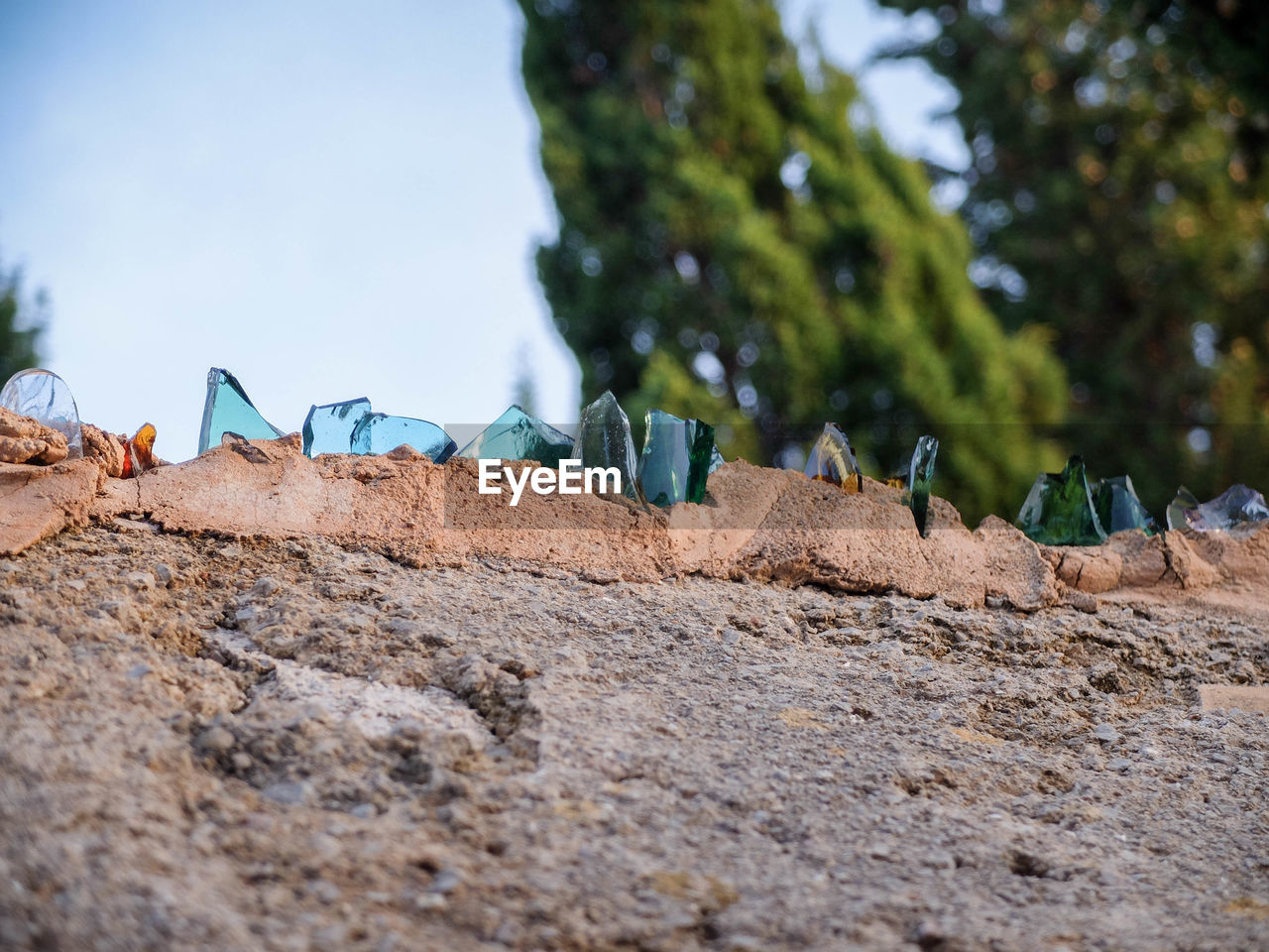 Low angle view of broken glass on retaining wall