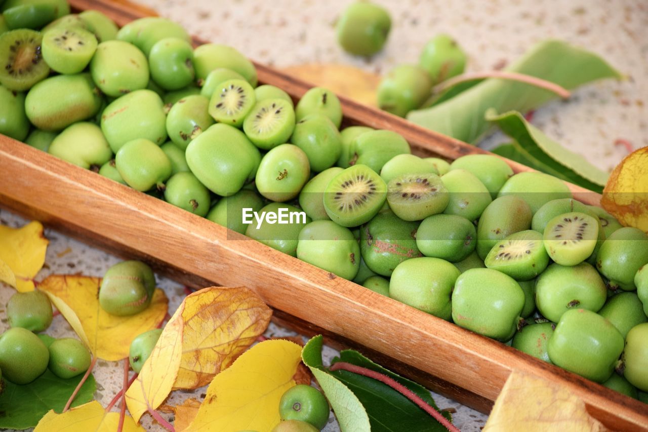 High angle view of kiwis in wooden container