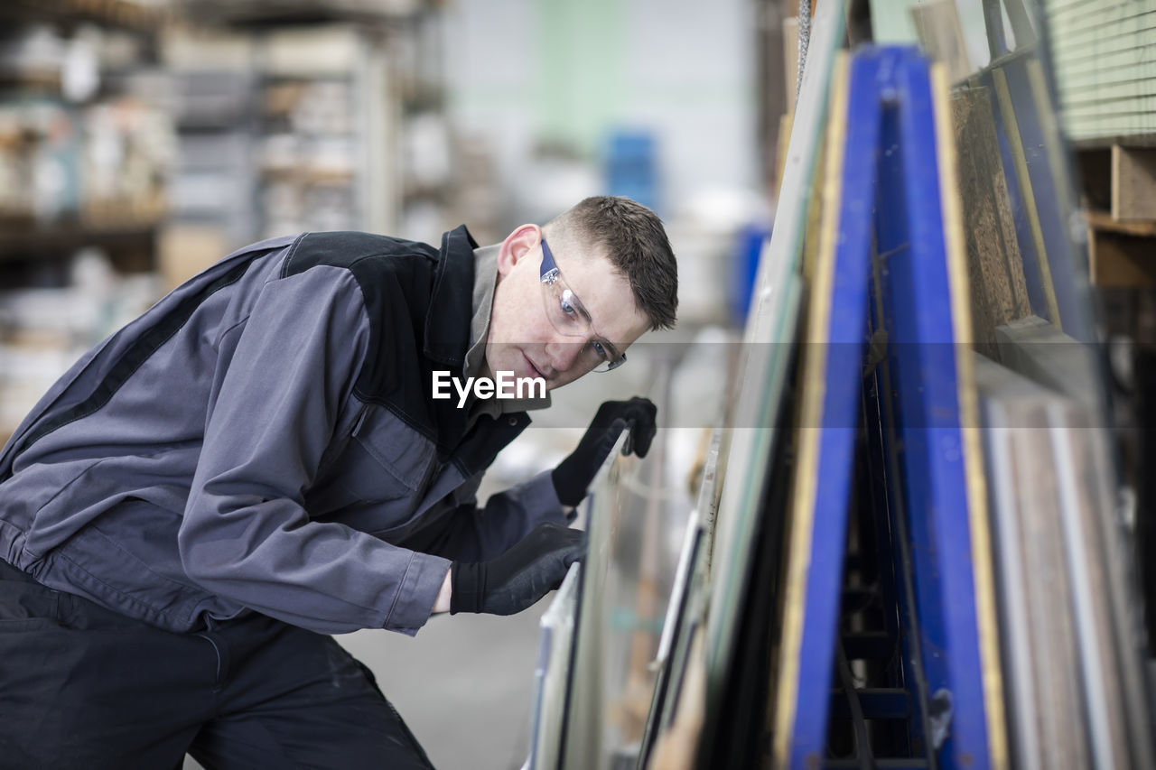 Technician male working in a store checking a glass plate