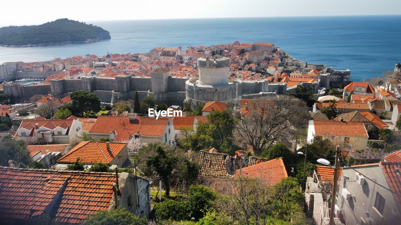 High angle view of townscape by sea