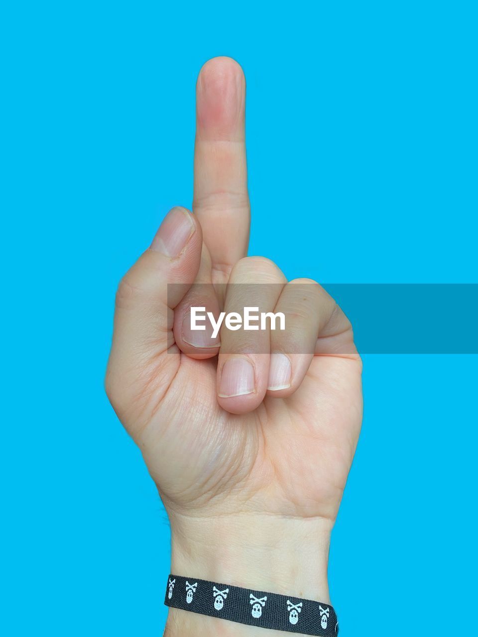 Close-up of human hand against blue background