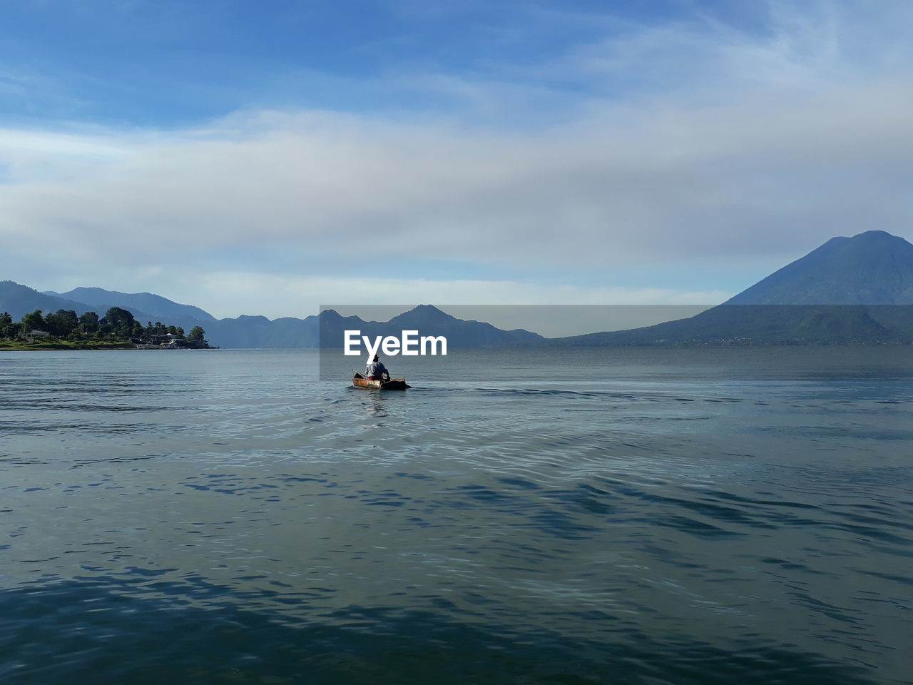 MAN ON SEA AGAINST SKY