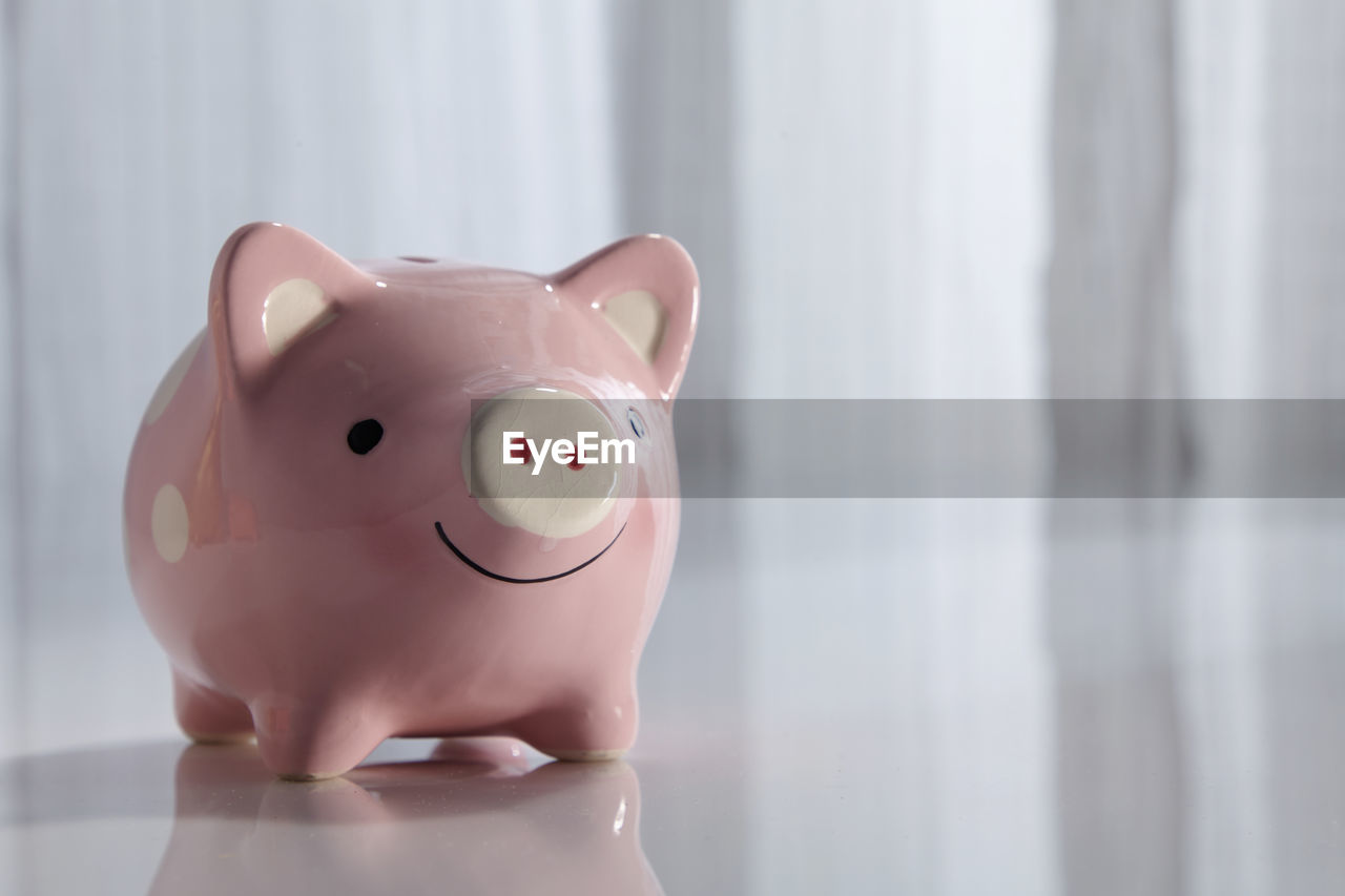 Close-up of pink piggy bank with copy space