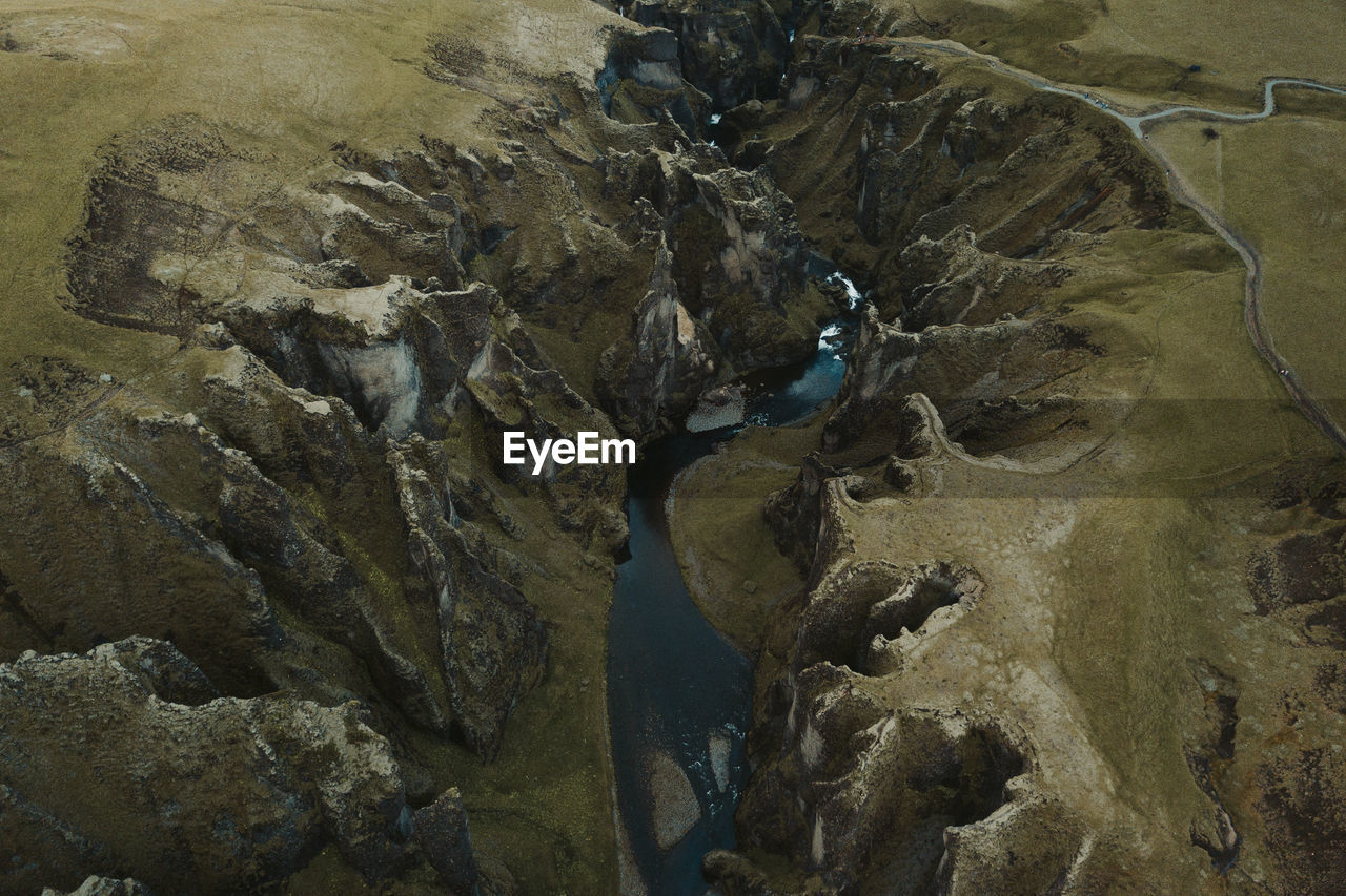 HIGH ANGLE VIEW OF A ROCK FORMATION AT BEACH