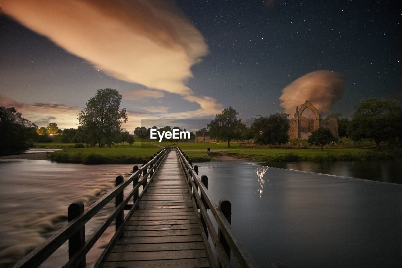 Scenic view of lake against sky at night