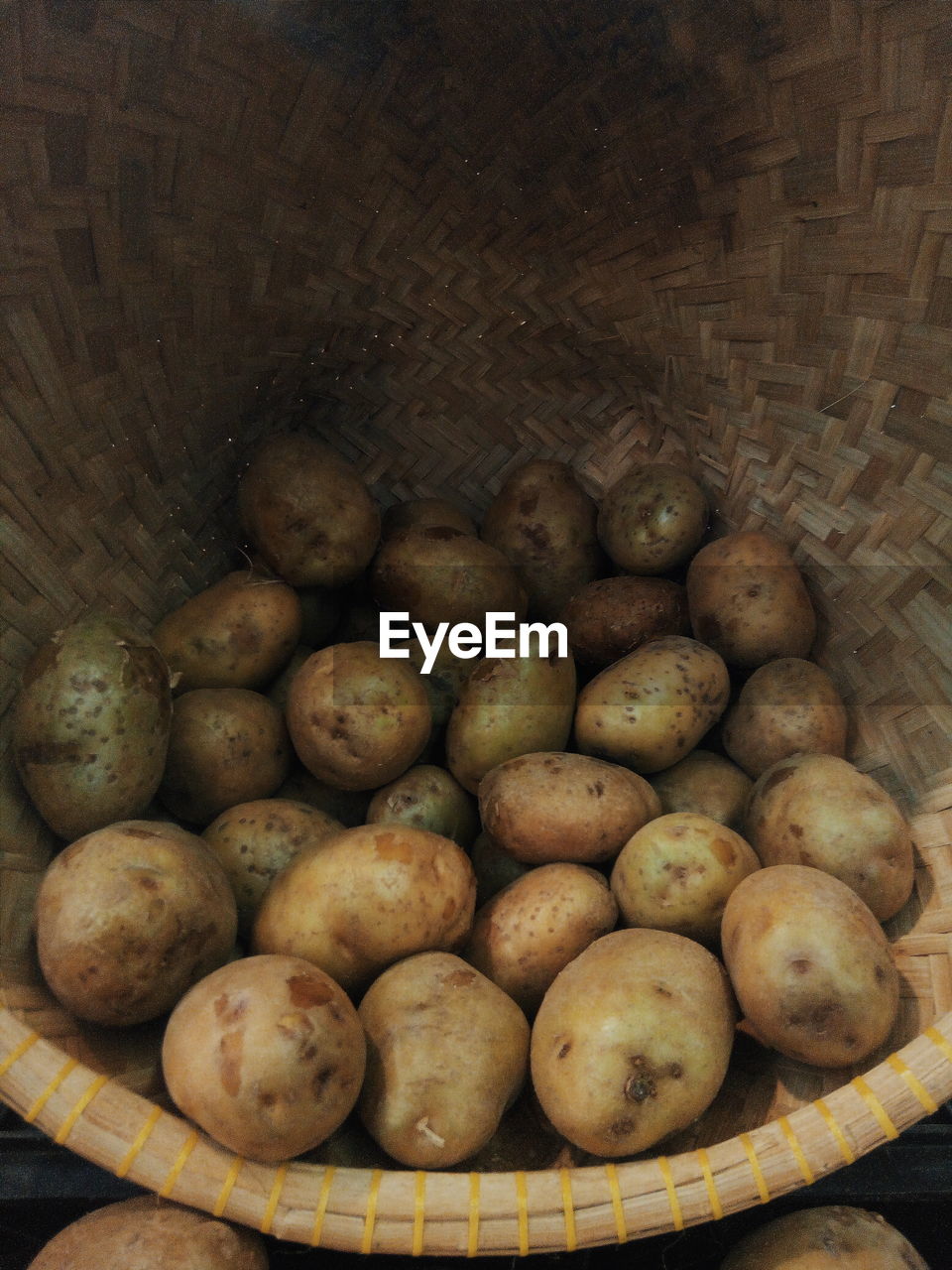 Raw potatoes in basket