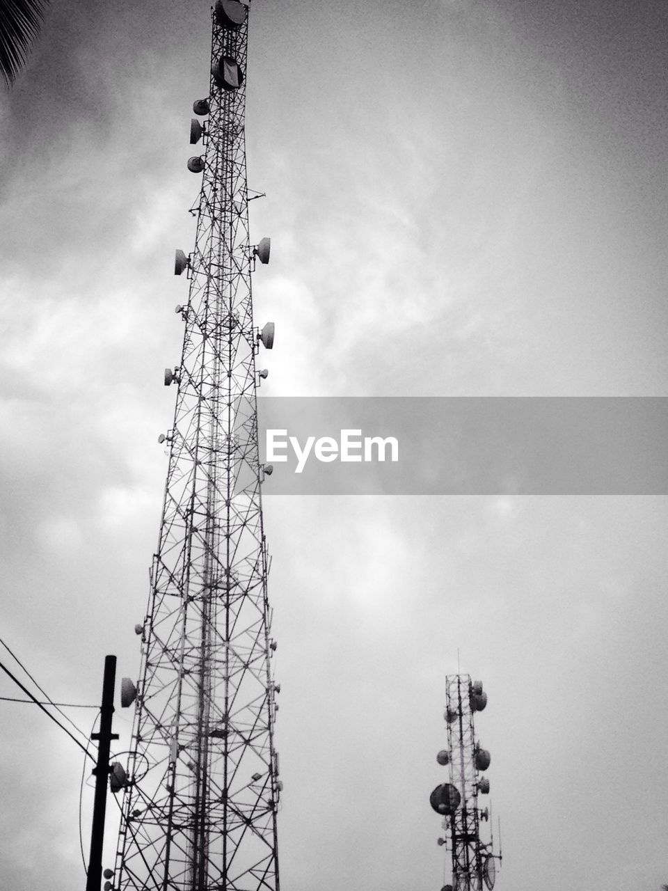 Low angle view of communications tower against sky