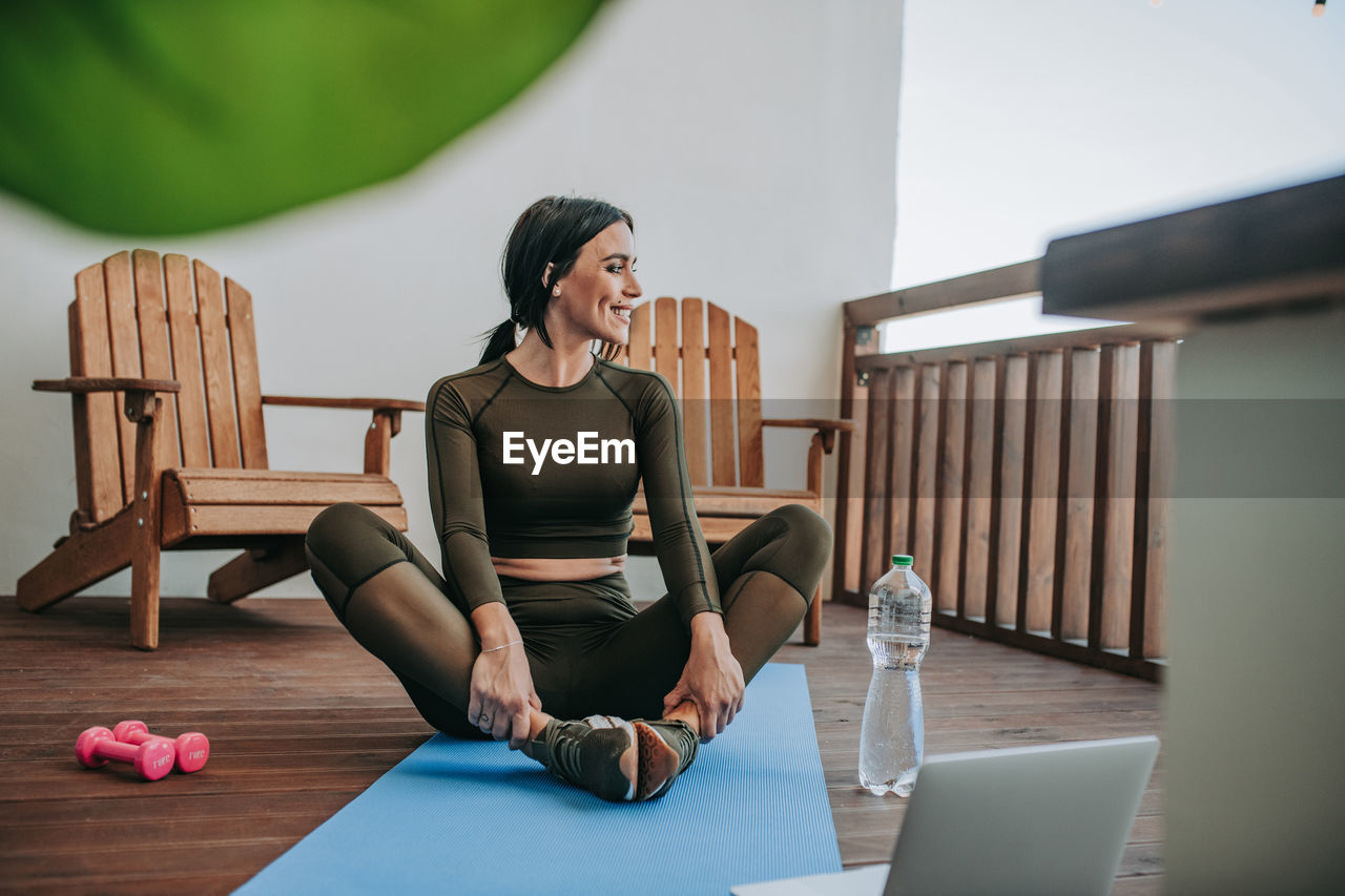 Woman sitting on table at home